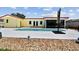 The yard features a beautiful swimming pool, a charming sunroom, and meticulously maintained landscaping at 4829 Commonwealth Rd, Palmetto, FL 34221