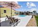 The yard features a beautiful swimming pool, complemented by comfortable lounge chairs and tropical landscaping at 4829 Commonwealth Rd, Palmetto, FL 34221