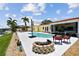 The backyard features a pool, waterfront view, fire pit, and outdoor seating, perfect for entertaining at 4829 Commonwealth Rd, Palmetto, FL 34221