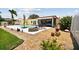 The backyard presents a pool, fire pit, lush landscaping, and comfortable seating, offering an inviting retreat at 4829 Commonwealth Rd, Palmetto, FL 34221