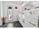 Bright bathroom with double sinks, a big mirror, and a door to the outside at 4829 Commonwealth Rd, Palmetto, FL 34221