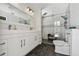 Modern bathroom with white cabinets, double sinks, and glass-enclosed shower at 4829 Commonwealth Rd, Palmetto, FL 34221