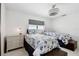 Bright bedroom furnished with two beds, two nightstands, and a modern ceiling fan at 4829 Commonwealth Rd, Palmetto, FL 34221