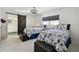 Bright bedroom with two beds, nightstands, and a sliding barn door that provides access to the bathroom at 4829 Commonwealth Rd, Palmetto, FL 34221