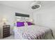 Comfortable bedroom with a decorative quilt and a modern ceiling fan at 4829 Commonwealth Rd, Palmetto, FL 34221