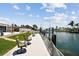 Waterfront property with a private dock featuring comfortable seating and serene canal views at 4829 Commonwealth Rd, Palmetto, FL 34221