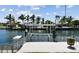 Dock with a boat lift on a sunny day, providing direct access to the waterfront and boating opportunities at 4829 Commonwealth Rd, Palmetto, FL 34221