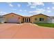 Beautiful single-story home featuring a well-manicured lawn and a spacious driveway at 4829 Commonwealth Rd, Palmetto, FL 34221