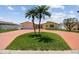 Charming single-story home with two palm trees and a circular driveway at 4829 Commonwealth Rd, Palmetto, FL 34221