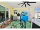 Enclosed lanai with a dining area, television, refrigerator, and an adjacent jacuzzi for comfortable outdoor living at 4829 Commonwealth Rd, Palmetto, FL 34221