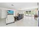 Bright living room with tile floors, comfortable seating, and a large TV at 4829 Commonwealth Rd, Palmetto, FL 34221