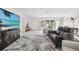 Well-lit living room with plush seating and large windows at 4829 Commonwealth Rd, Palmetto, FL 34221