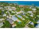 Lovely aerial view of a waterfront neighborhood with canals, pools, lush greenery and beach access at 507 Spring Ave, Anna Maria, FL 34216