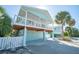 Inviting beach house showcasing a spacious covered porch, convenient ground-level access, and ample parking at 507 Spring Ave, Anna Maria, FL 34216