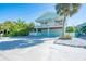 Charming coastal home with a spacious driveway, lush landscaping, and a welcoming front porch at 507 Spring Ave, Anna Maria, FL 34216
