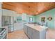 Beautiful kitchen with island, stainless steel appliances, and dining area at 507 Spring Ave, Anna Maria, FL 34216