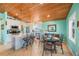 Bright, open kitchen with a large island, modern stainless steel appliances, and stylish dining area at 507 Spring Ave, Anna Maria, FL 34216