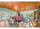 Inviting living room featuring wood ceiling, tile floors, comfortable seating, and scenic views at 507 Spring Ave, Anna Maria, FL 34216