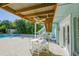 Charming patio with a dining set, ceiling fan, and access to the pool area, ideal for outdoor gatherings at 507 Spring Ave, Anna Maria, FL 34216
