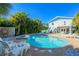 Inviting pool and spa area with brick pavers, lush greenery, and comfortable lounge chairs for relaxing at 507 Spring Ave, Anna Maria, FL 34216