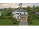 An aerial view shows a luxurious home with a backyard pool surrounded by lush greenery at 5651 Trevesta Pl, Palmetto, FL 34221