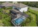 Aerial view showcases a screened-in pool and a spacious backyard with privacy at 5651 Trevesta Pl, Palmetto, FL 34221
