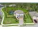 Gorgeous aerial view of home with a screened-in pool, lush greenery, and a long driveway at 5651 Trevesta Pl, Palmetto, FL 34221