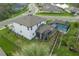 Aerial view of the backyard with a pool, lush lawn, and black metal fence, providing a serene outdoor space at 5651 Trevesta Pl, Palmetto, FL 34221
