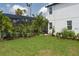 Beautiful backyard featuring a screened-in pool, lush landscaping, and a well-maintained lawn at 5651 Trevesta Pl, Palmetto, FL 34221