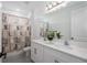 Bathroom with a double sink vanity with white cabinetry, and a large mirror and tub-shower combo at 5651 Trevesta Pl, Palmetto, FL 34221