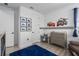 bedroom with Cars themed decor, neutral grey furniture, and a blue rug on wood floors at 5651 Trevesta Pl, Palmetto, FL 34221