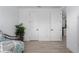 Minimalist bedroom featuring wood-look floors, a comfortable daybed, and white walls at 5651 Trevesta Pl, Palmetto, FL 34221