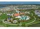Aerial shot of the community pool and clubhouse with parking and playground, set amidst lush landscaping and mature trees at 5651 Trevesta Pl, Palmetto, FL 34221