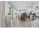 Open-concept with chandelier, kitchen in background, and lots of light at 5651 Trevesta Pl, Palmetto, FL 34221