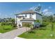 Lovely two-story home with a paved driveway, manicured lawn, and professional landscaping at 5651 Trevesta Pl, Palmetto, FL 34221