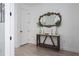 Hallway with console table, ornate mirror, and light hardwood flooring at 5651 Trevesta Pl, Palmetto, FL 34221