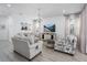 Inviting living room with a chandelier, stylish furniture, and a mounted television at 5651 Trevesta Pl, Palmetto, FL 34221