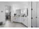 Elegant main bathroom features double vanities, modern lighting, tile floors, and access to walk-in closet at 5651 Trevesta Pl, Palmetto, FL 34221