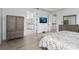 Spacious main bedroom boasts wood flooring, an armoire, and doorway views to the primary bathroom at 5651 Trevesta Pl, Palmetto, FL 34221