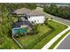 Aerial view of a home featuring a screened-in pool with lush landscaping and a black metal fence at 5651 Trevesta Pl, Palmetto, FL 34221