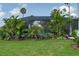 Backyard pool area features a screened enclosure and lush tropical landscaping for ultimate privacy at 5651 Trevesta Pl, Palmetto, FL 34221