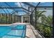 Outdoor living at its finest with a screened-in pool, spa, and comfortable patio seating area at 5651 Trevesta Pl, Palmetto, FL 34221