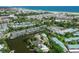 Breathtaking aerial view showcasing waterfront homes with boat docks and stunning beachside proximity at 5681 Midnight Pass Rd # 104, Sarasota, FL 34242