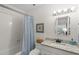 Bathroom with granite vanity top, shower-tub combo, and tile at 5681 Midnight Pass Rd # 104, Sarasota, FL 34242