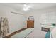 Bedroom with hardwood floors, closet, and a desk by the window at 5681 Midnight Pass Rd # 104, Sarasota, FL 34242