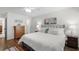 Bright bedroom with hardwood floors, ceiling fan, dresser, and stylish decor at 5681 Midnight Pass Rd # 104, Sarasota, FL 34242