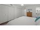 White bedroom featuring hardwood floors, a closet, and natural light at 5681 Midnight Pass Rd # 104, Sarasota, FL 34242