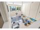 Up high shot of the dining area with vaulted ceilings, ceiling fan, and a sliding glass door leading to the pool at 5681 Midnight Pass Rd # 104, Sarasota, FL 34242