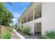 Inviting condo exterior with lush landscaping and a walkway leading to the entrance at 5681 Midnight Pass Rd # 104, Sarasota, FL 34242