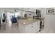 Open-concept kitchen with granite countertops and stainless steel appliances overlooking the living area at 5681 Midnight Pass Rd # 104, Sarasota, FL 34242
